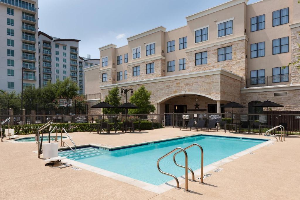 a swimming pool in front of a building at Residence Inn Fort Worth Cultural District in Fort Worth
