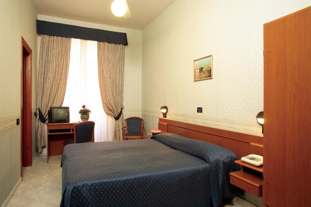 Postel nebo postele na pokoji v ubytování Hotel Dina
