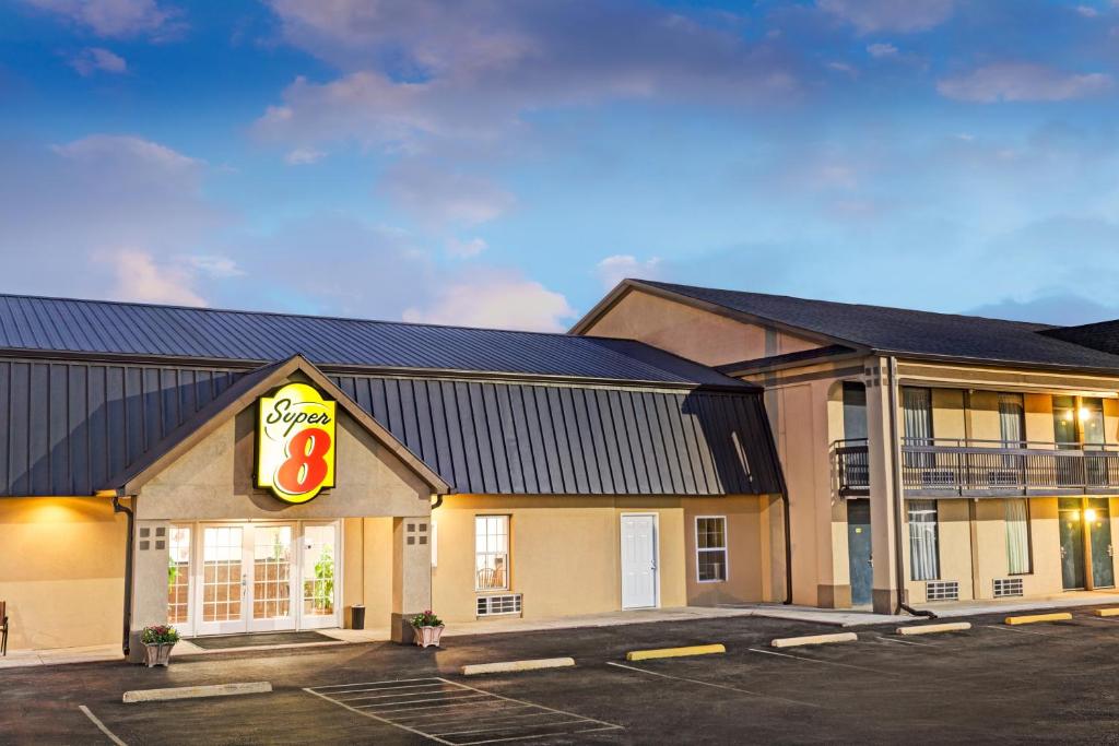 a fast food restaurant with a sign in a parking lot at Super Inn & Suites Carrollton in Carrollton