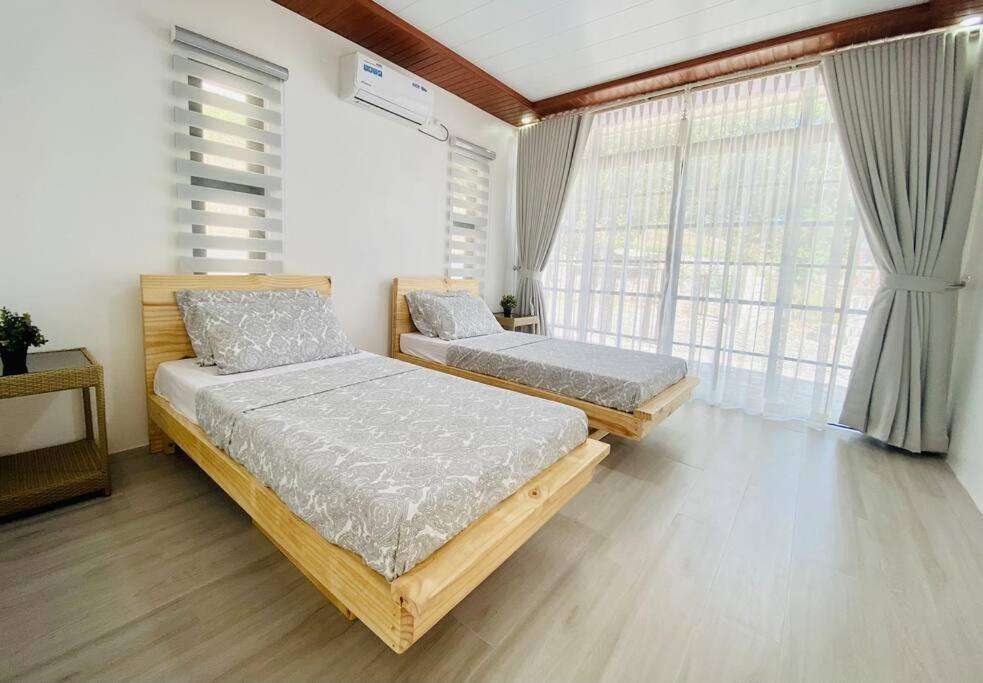 a bedroom with two beds and a large window at The Peak Villa w/ Infinity Pool! (20mins to Clark) 