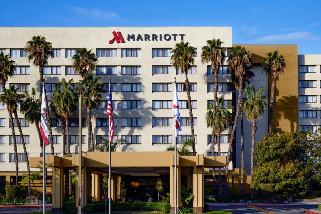 a hotel with palm trees in front of it at Long Beach Marriott in Long Beach