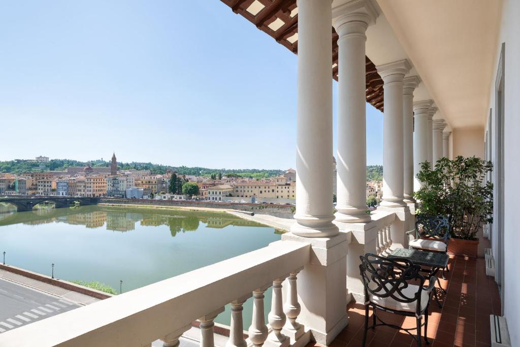 a balcony with a view of a river at The St. Regis Florence in Florence