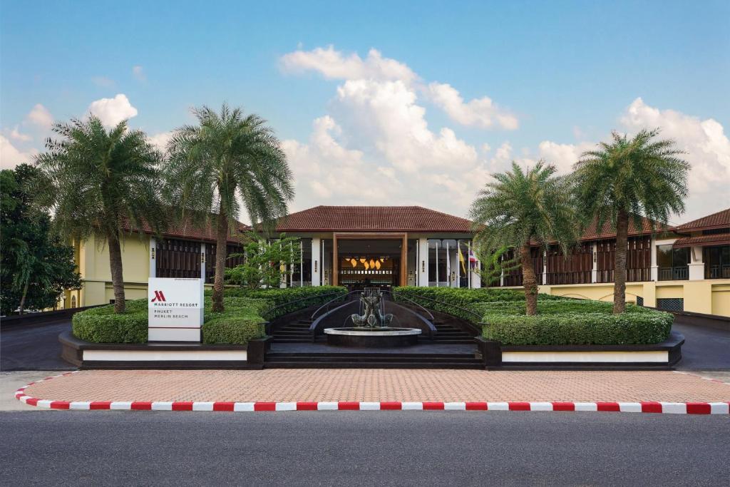 a resort with a fountain in front of a building at Phuket Marriott Resort & Spa, Merlin Beach in Patong Beach