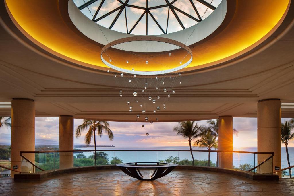 a large lobby with a large circular ceiling and a table at The Westin Hapuna Beach Resort in Hapuna Beach