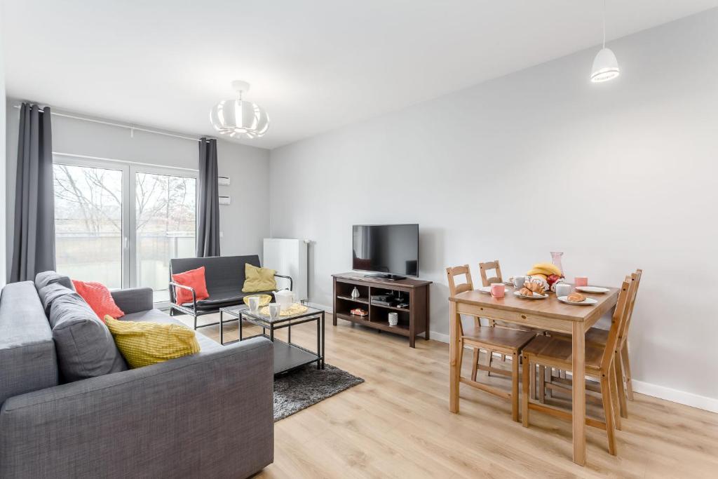 a living room with a couch and a table at Chill Apartments Marywilska in Warsaw