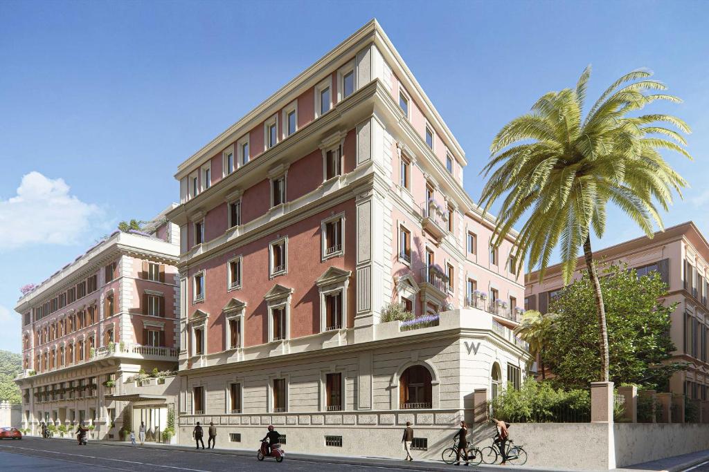 um grande edifício com uma palmeira em frente em W Rome em Roma
