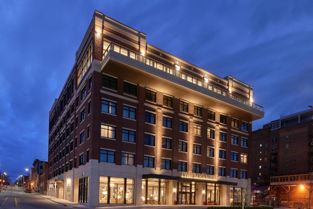 a large building with lights on top of it at The Merrill Hotel & Conference Center, Muscatine, a Tribute Portfolio Hotel in Muscatine