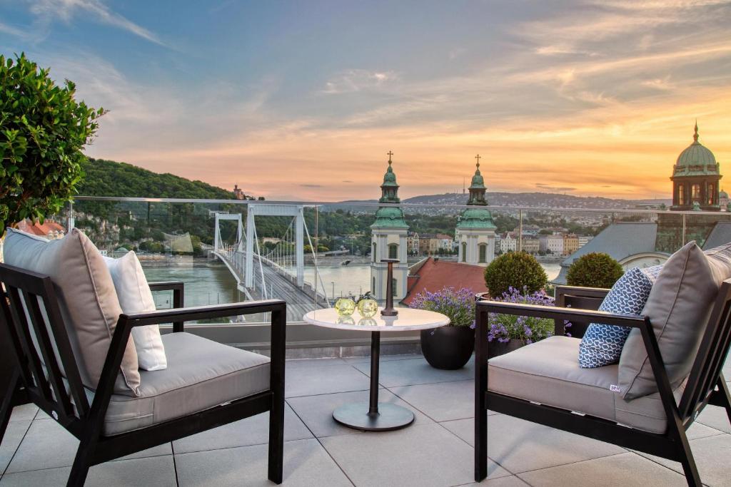 a balcony with a table and chairs and a view at Matild Palace, a Luxury Collection Hotel in Budapest