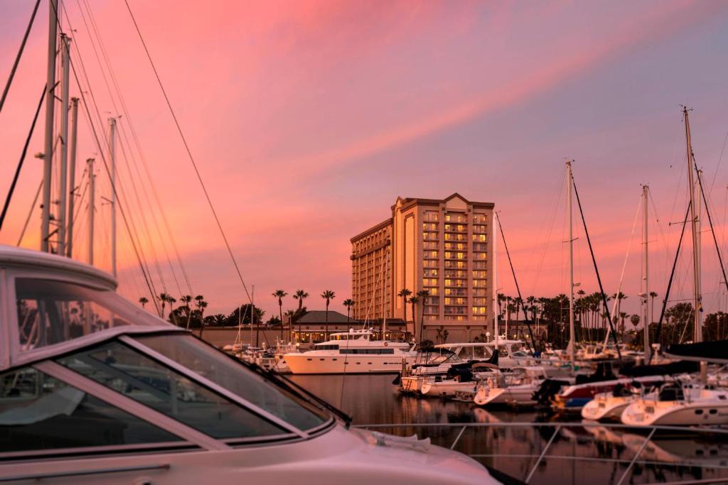 a group of boats docked in a marina with a building at The Ritz-Carlton, Marina del Rey in Los Angeles