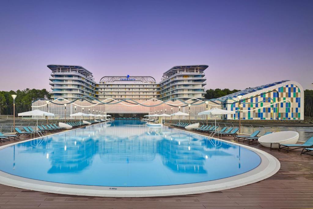 a large swimming pool in front of a building at Paragraph Resort & Spa Shekvetili, Autograph Collection in Shekvetili