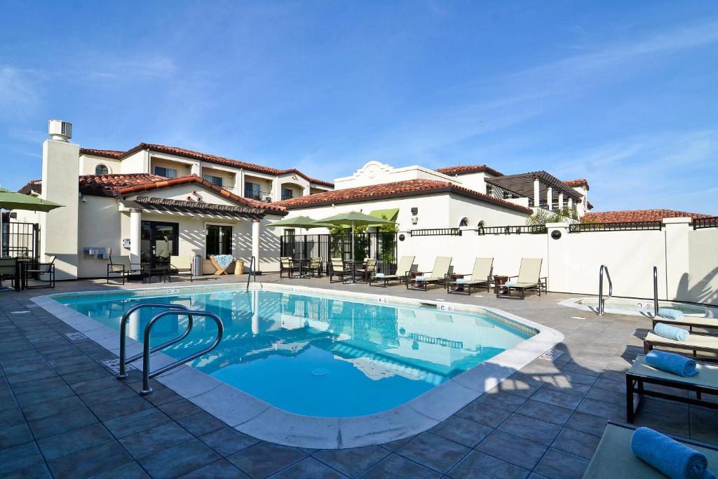 a swimming pool in front of a house at Fairfield Inn & Suites Santa Cruz - Capitola in Capitola