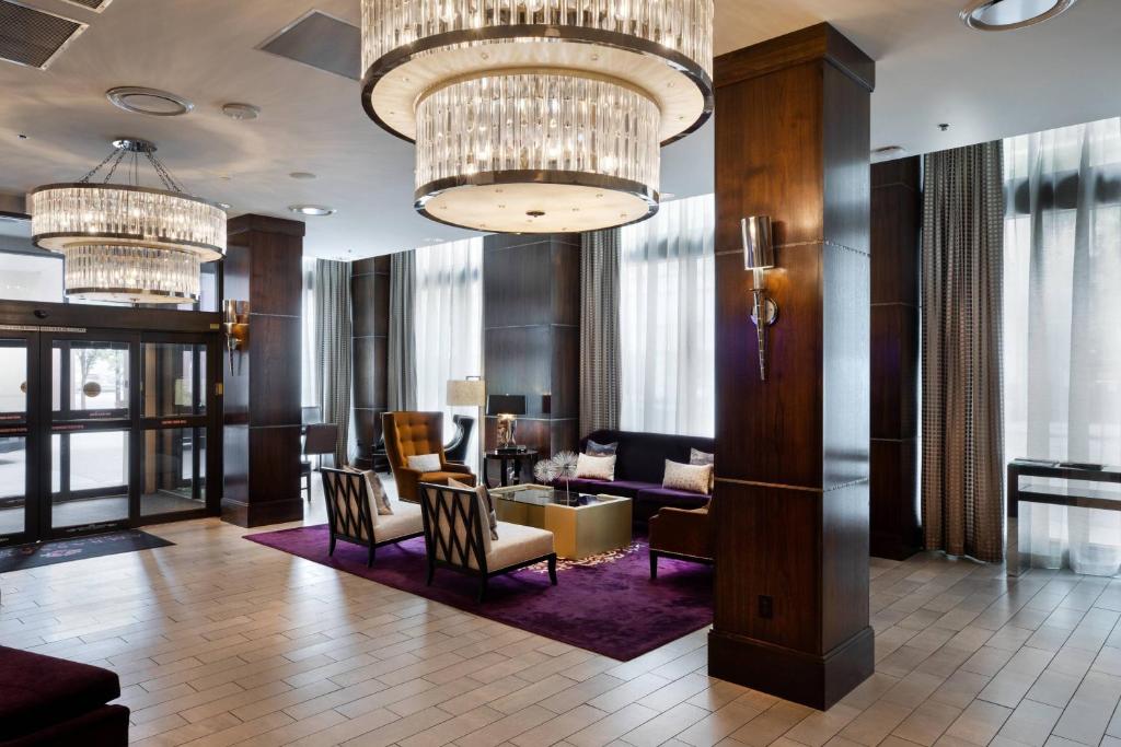 a lobby of a hotel with chandeliers at Ambassador Hotel Wichita, Autograph Collection in Wichita