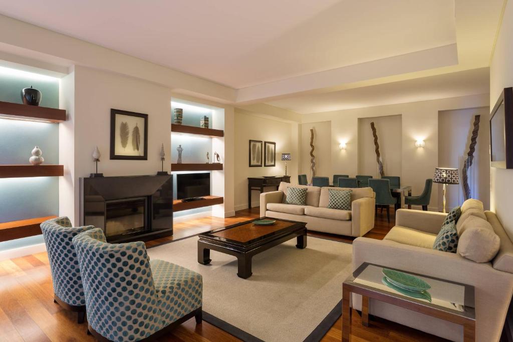 a living room filled with furniture and a fireplace at Sheraton Cascais Resort - Hotel & Residences in Cascais