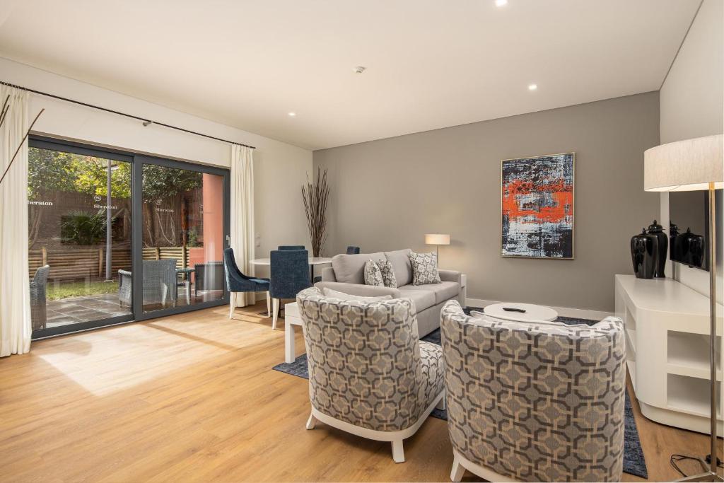 a living room with a couch and chairs at Sheraton Cascais Resort - Hotel & Residences in Cascais