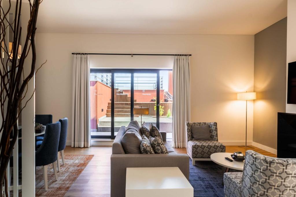 a living room with a couch and chairs at Sheraton Cascais Resort - Hotel & Residences in Cascais