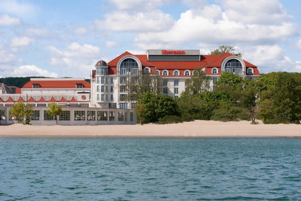 a hotel on the beach with the water at Sheraton Sopot Hotel in Sopot