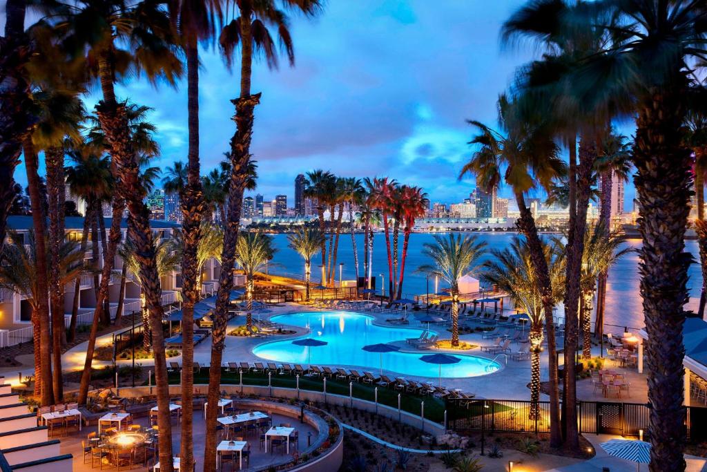 a view of a resort with palm trees and the water at Coronado Island Marriott Resort & Spa in San Diego