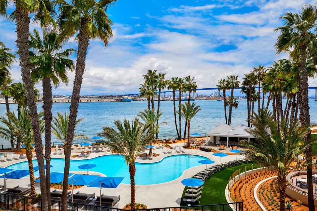 a view of the pool at the resort with palm trees at Coronado Island Marriott Resort & Spa in San Diego