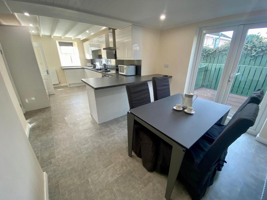 a kitchen and dining room with a table and chairs at Mountain Dream Ramsey Isle of Man in Ramsey