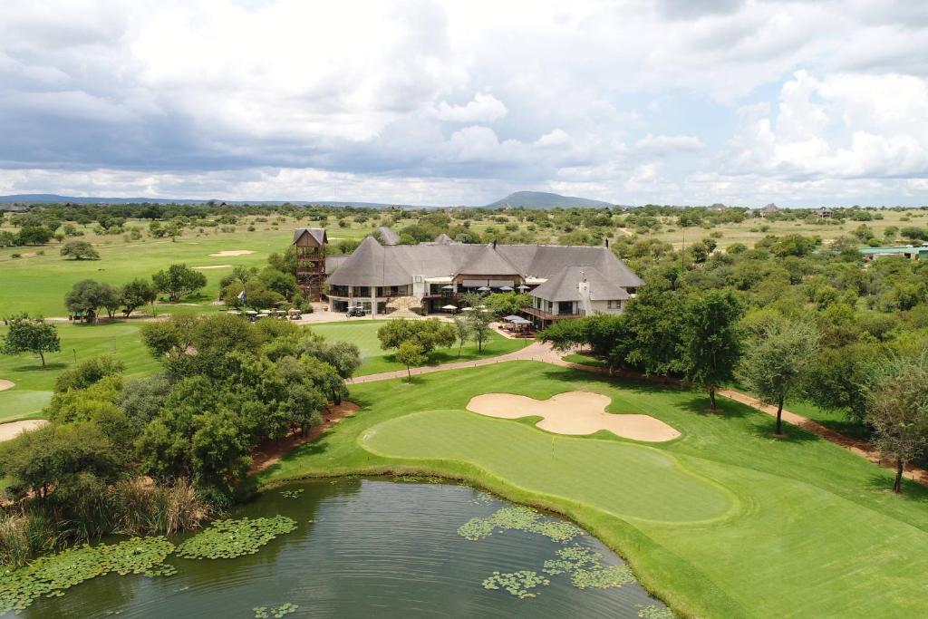 an aerial view of a golf course with a pond at Zebula Golf Estate and Spa - Zebula Golfers Lodge in Mabula