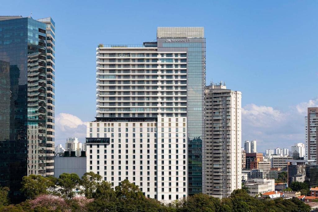 a tall white building in a large city at JW Marriott Hotel Sao Paulo in Sao Paulo