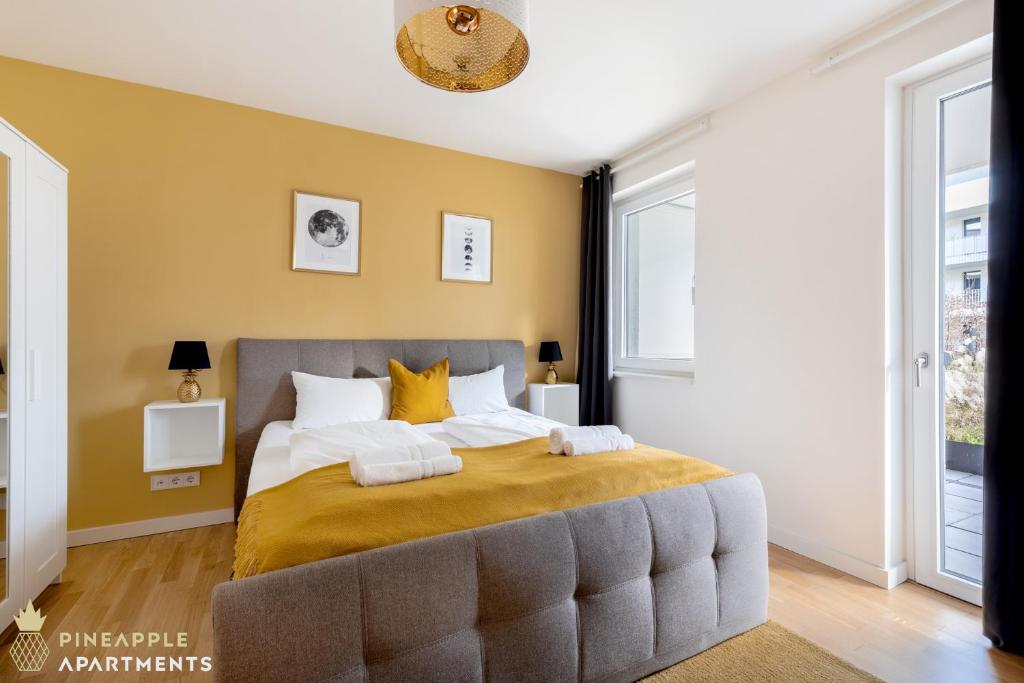a bedroom with a large bed with yellow walls at Pineapple Apartments Dresden Altstadt I - 117 qm - 1x free parking in Dresden