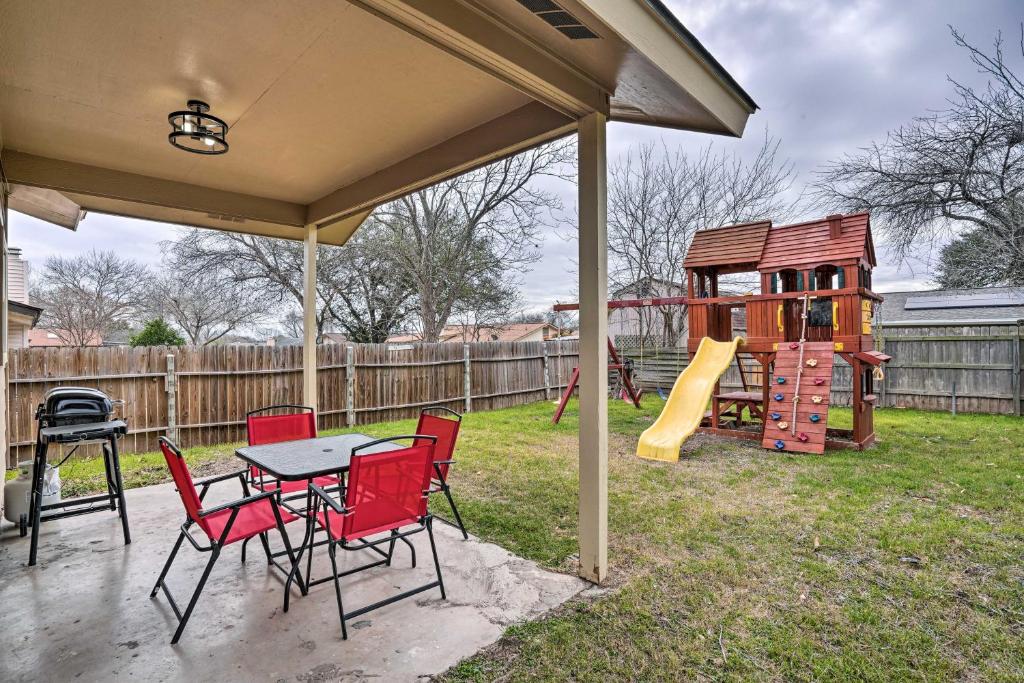 a patio with a table and chairs and a playground at Pet-Friendly San Antonio Vacation Rental! in San Antonio