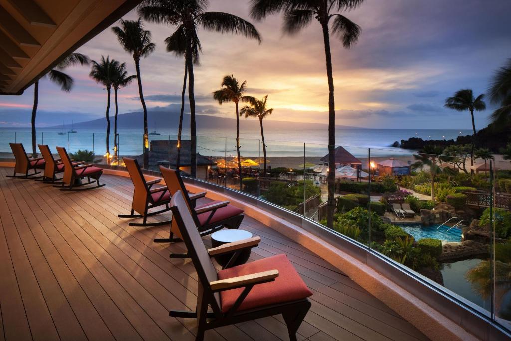 a balcony with chairs and a view of the ocean at Sheraton Maui Resort & Spa in Lahaina