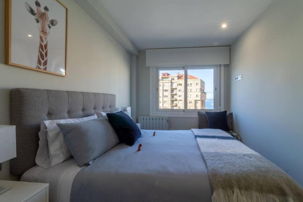 A bed or beds in a room at Moderno, Castro, Corazón de Vigo