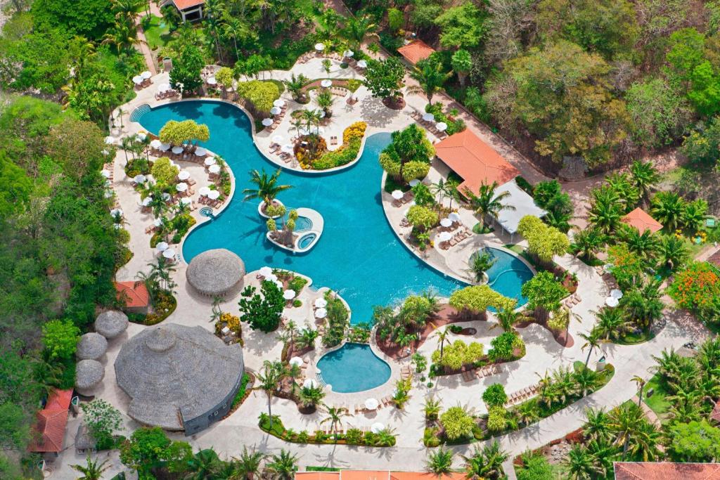 an overhead view of a pool at a resort at The Westin Reserva Conchal, an All-Inclusive Golf Resort & Spa in Playa Conchal