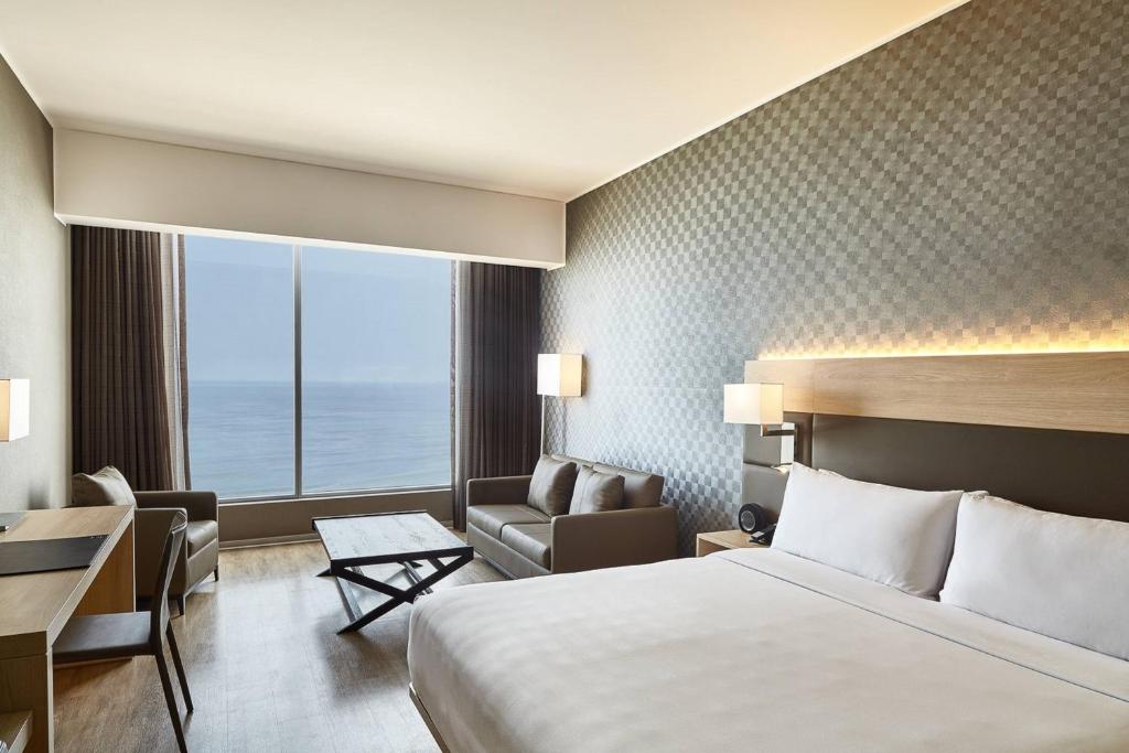 a hotel room with a large bed and a desk at AC Hotel by Marriott Lima Miraflores in Lima