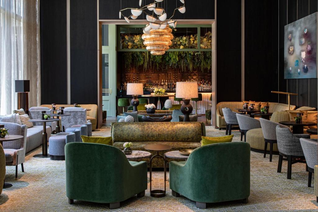 a lobby with couches and chairs and a table at The Ritz-Carlton New York, NoMad in New York