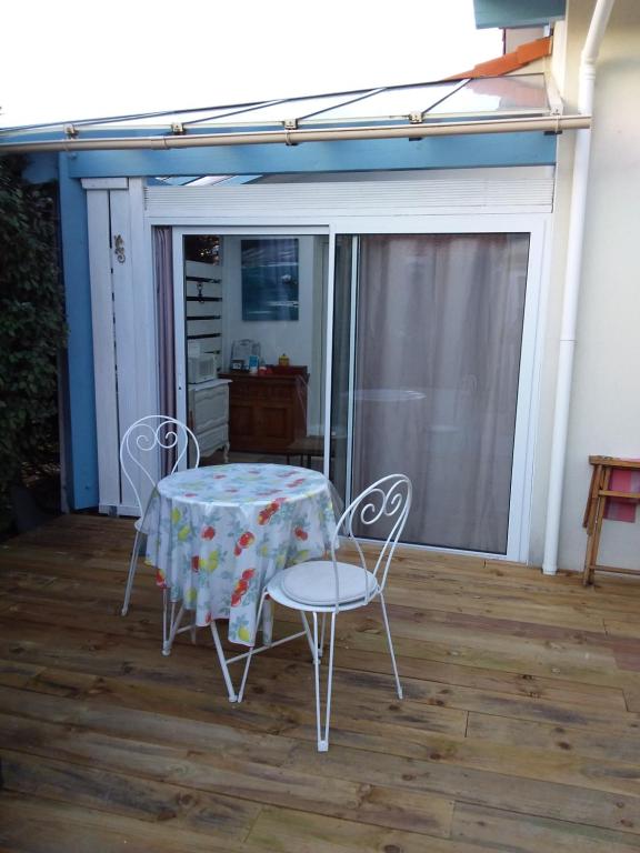 a table and two chairs on a patio at Chambre Privée Chez l'Habitant in Capbreton