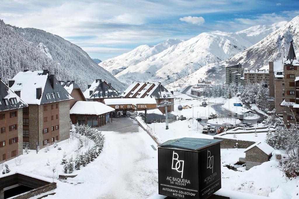 a town covered in snow with mountains in the background at Hotel AC Baqueira Ski Resort, Autograph Collection in Baqueira-Beret