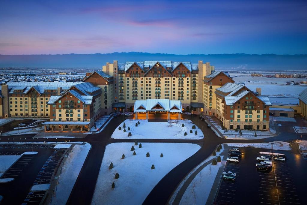 a large building with snow on the ground at Gaylord Rockies Resort & Convention Center in Aurora
