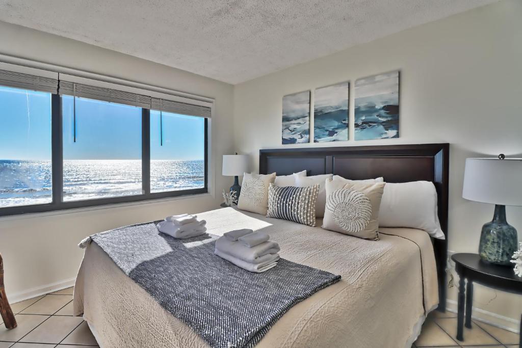 a bedroom with a bed with a view of the ocean at Direct Ocean Front 3BR/2BA Dog Friendly in Myrtle Beach