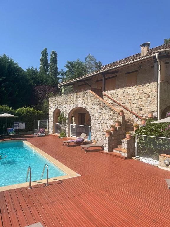 une maison avec une piscine à côté d'un bâtiment dans l'établissement Mas De Sarjac, à Saint-Andéol-de-Vals