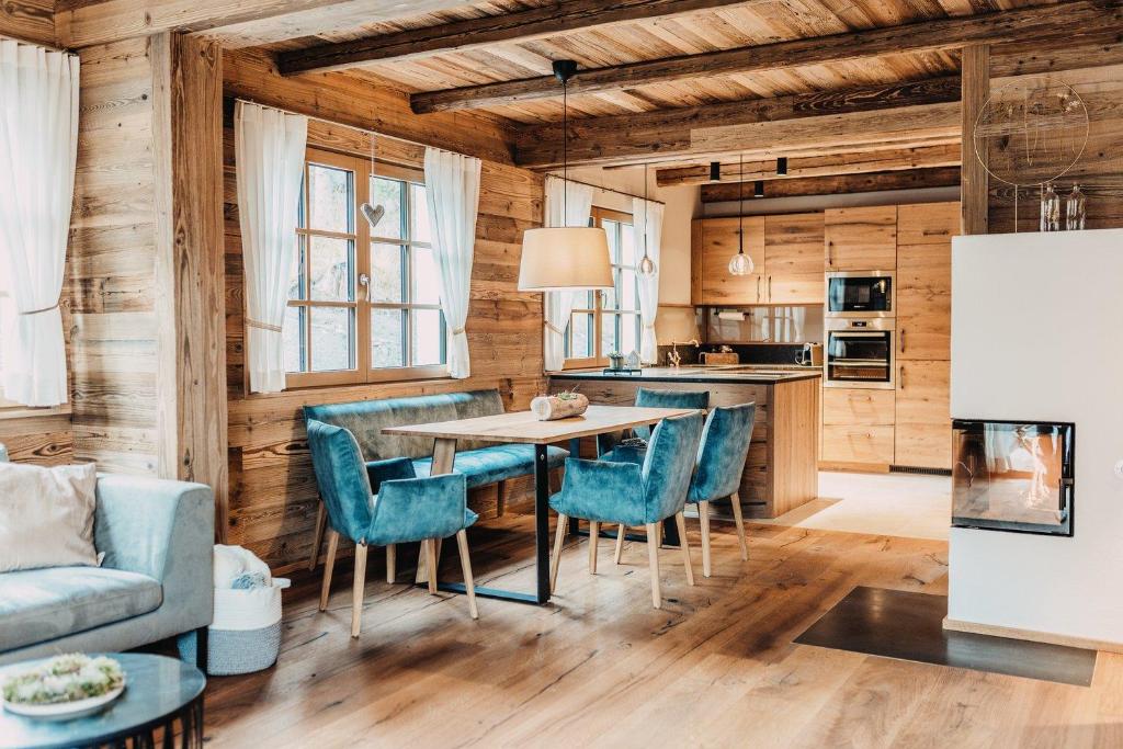 a kitchen and dining room with a table and chairs at Chalet Tannalm in Bad Kleinkirchheim