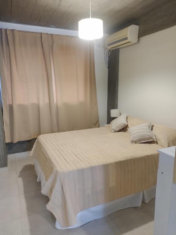 1 dormitorio con 1 cama grande y ventana en Jujuy 303 en San Miguel de Tucumán