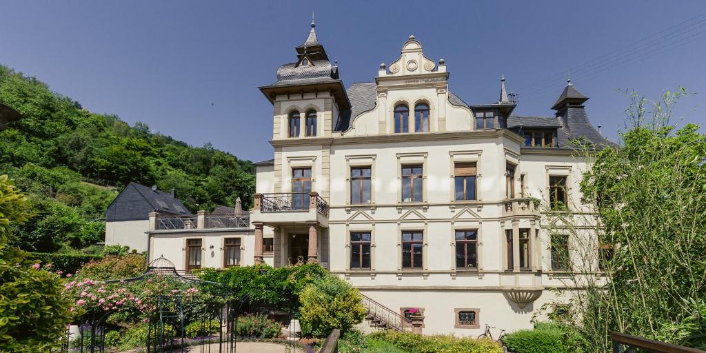 a large white building with a clock tower on top at FEWO Königsberg Weingut C A Haussmann in Traben-Trarbach