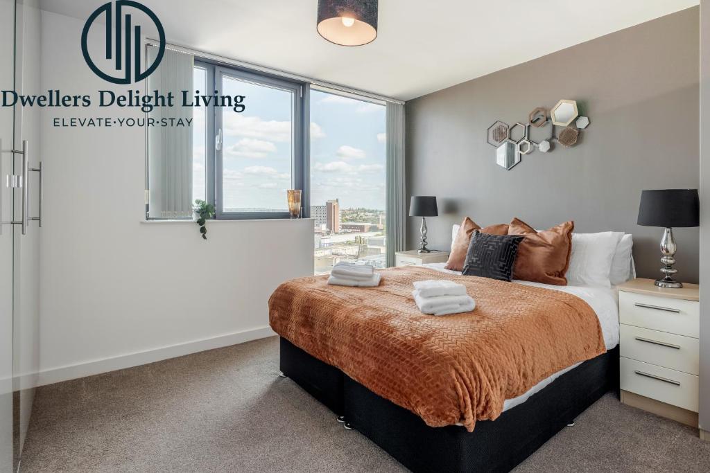 a bedroom with a large bed and a window at Basildon - Dwellers Delight Living Ltd Serviced Accommodation , 2 Bedroom Penthouse Basildon Essex with Free Wifi & secure parking in Basildon