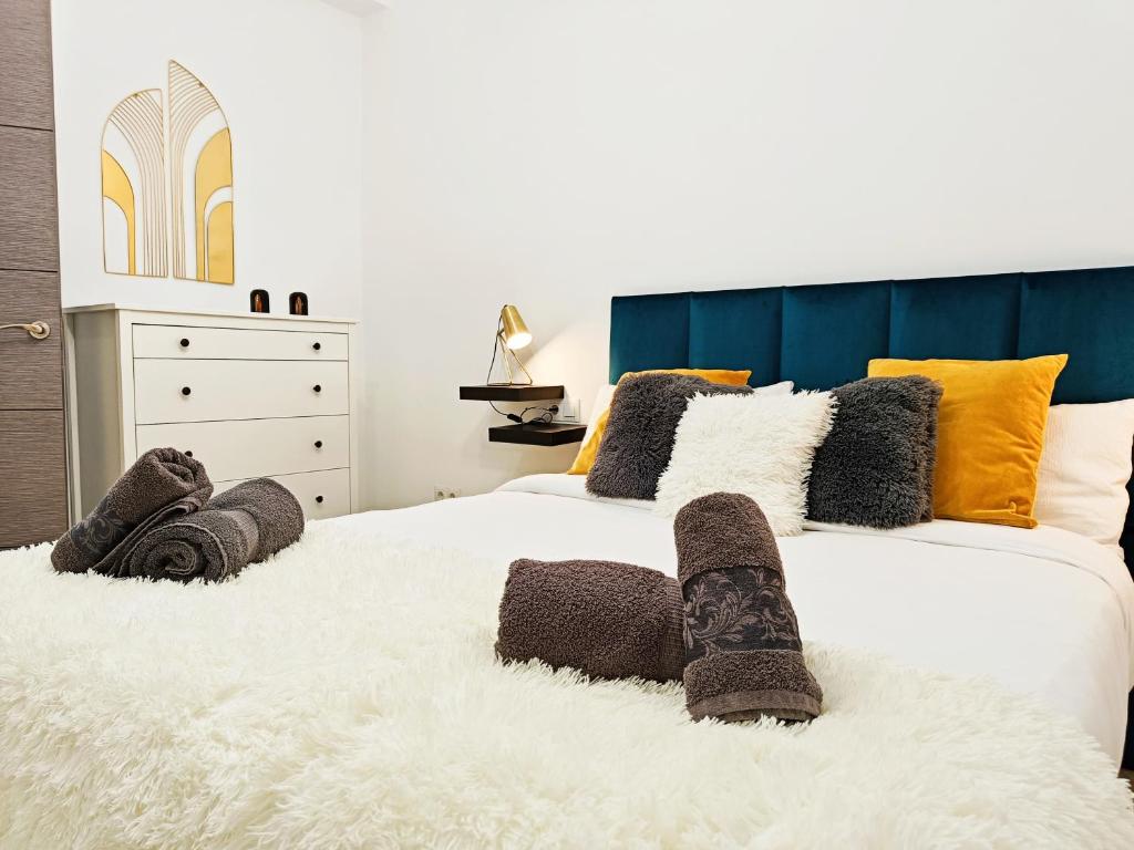 a bedroom with two white beds with pillows at La Brisa apartamento in Málaga