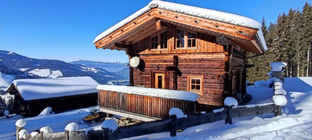 a log cabin in the snow at Chalet zum Feldalphorn Prädasten WILD605 in Schwarzenau