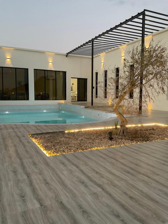 a house with a swimming pool in front of it at Seagemfuj in Fujairah