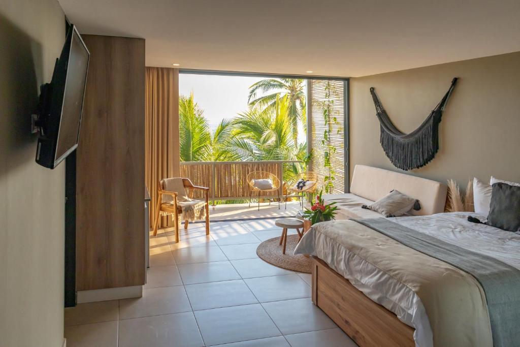 a bedroom with a bed and a view of a patio at Fishermans Resort Life in La Libertad