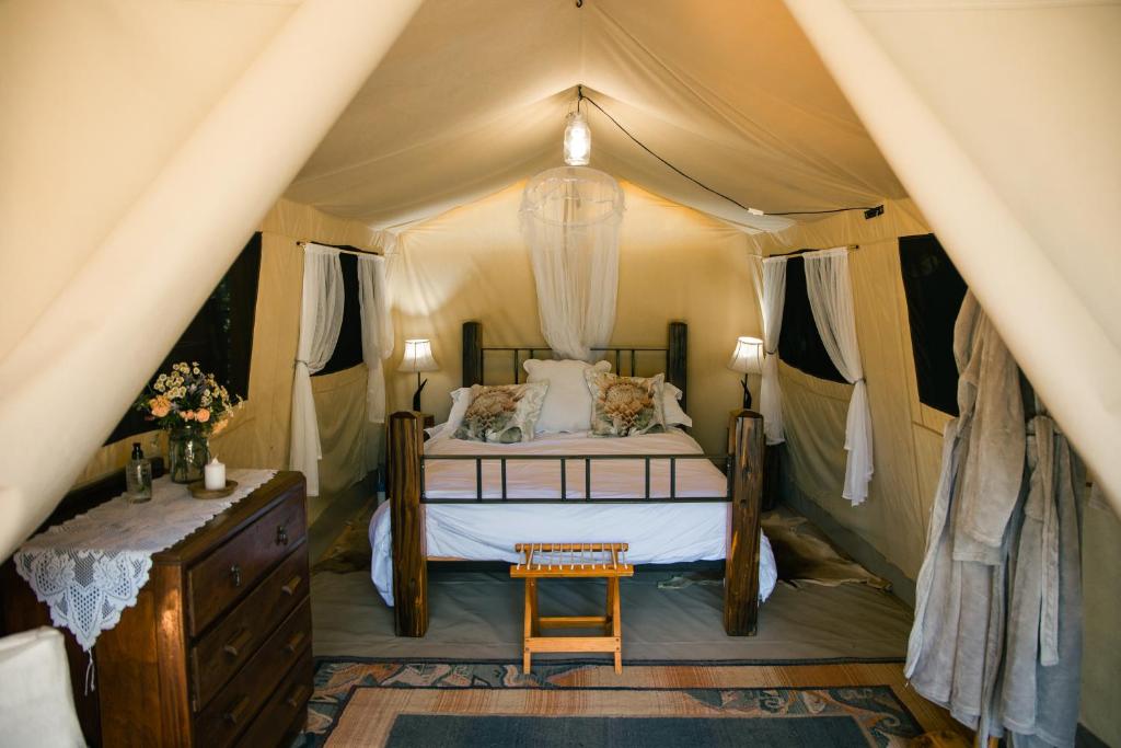 a bedroom with a bed in a tent at HighlandsView in Swellendam