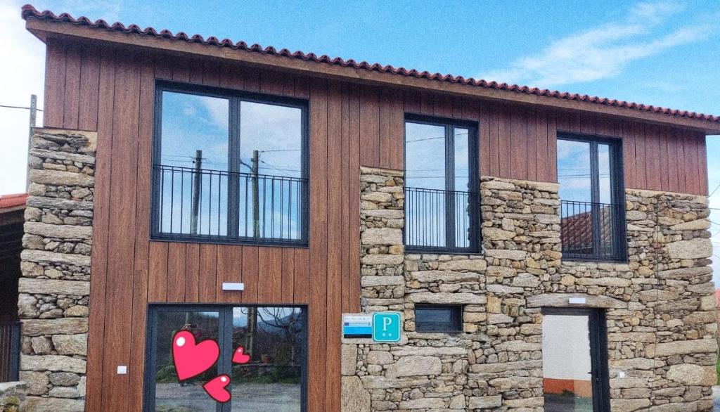 a building with windows on the side of it at Armada Sacra A Teixeira in Ourense