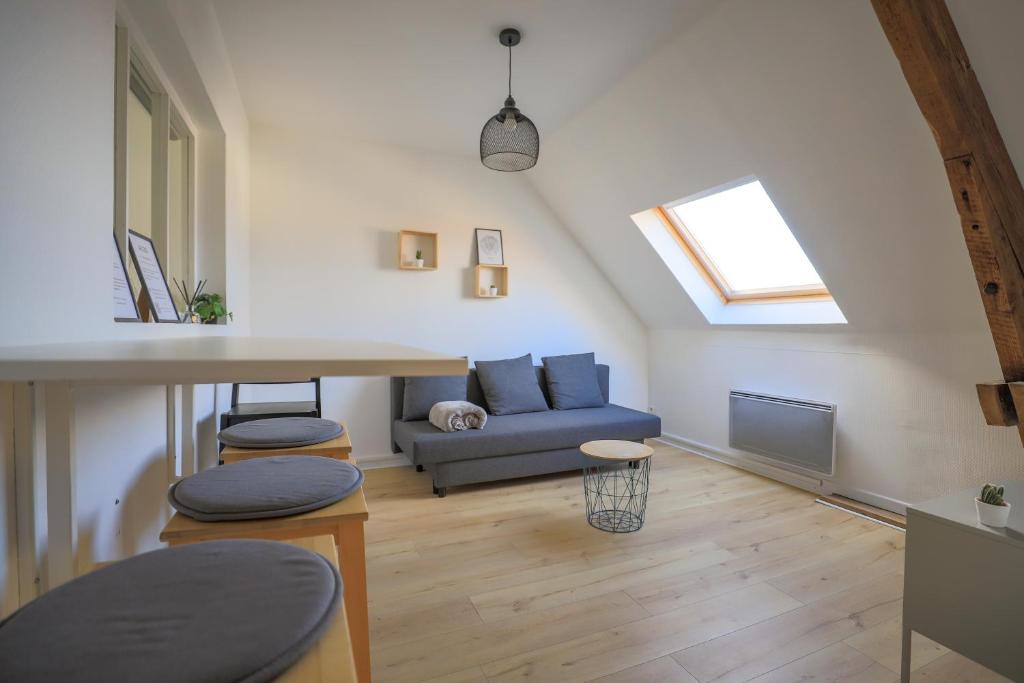 a living room with a blue couch and a window at Casa Nostra - Arrière Gare in Arras