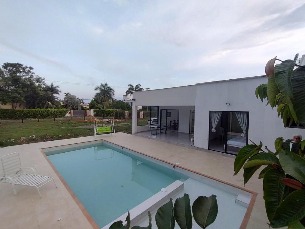 a swimming pool in front of a house at CASA CAMPESTRE VILLALUPO in Villavicencio