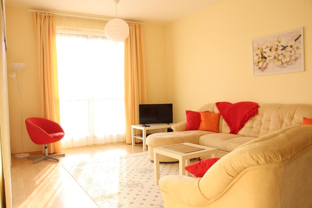 a living room with two couches and a tv at Panoráma Apartman in Cegléd